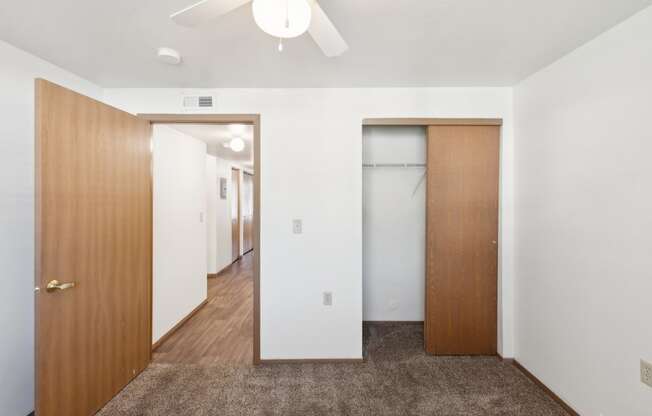 a bedroom with a closet and a door to a hallway