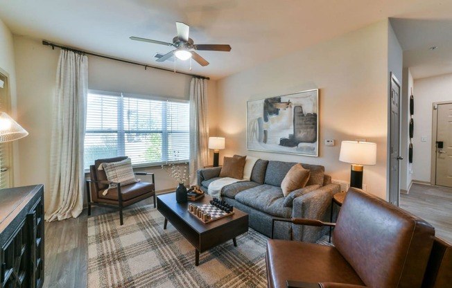 Gorgeous Modern Living Room with Wood Plank Vinyl Flooring (in Select Units) at Ashby at Ross Bridge, Hoover