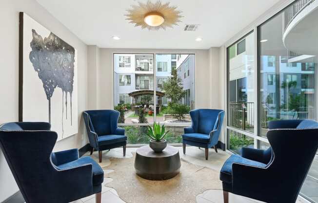 Indoor seating by large windows at Harlow River Oaks in Houston, TX