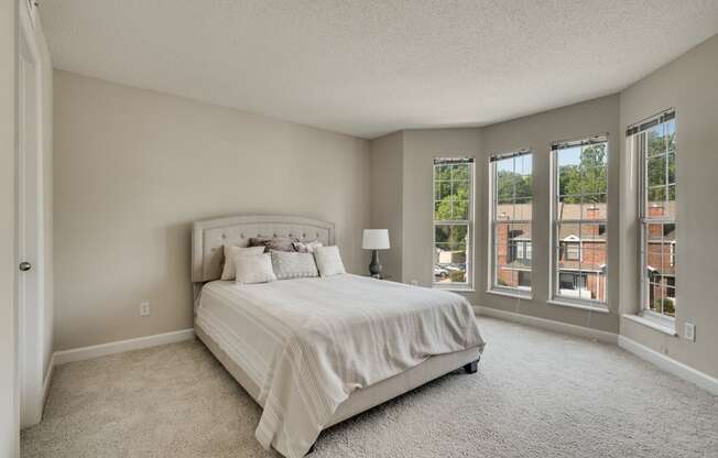 Spacious Carpeted Bedroom With Bay Windows