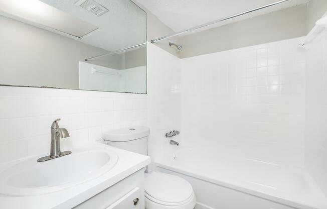 a room with a sink and a mirror