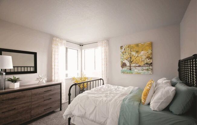 A bedroom with a bed, nightstand, and a painting on the wall.