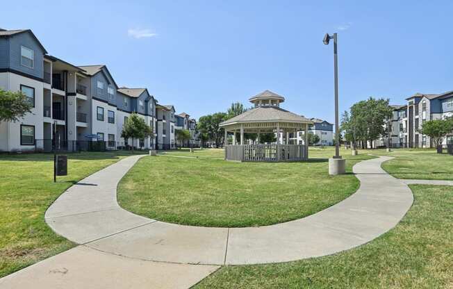 a park with a gazebo in the middle of an apartment complex