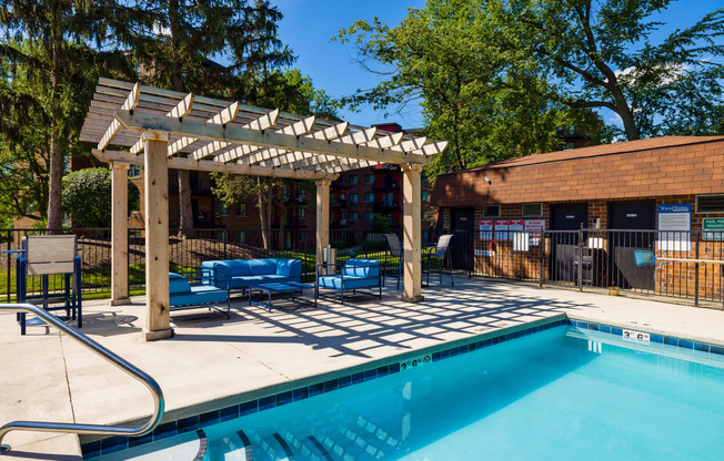 outdoor swimming pool with nearby pergola at The Bennington Apartments