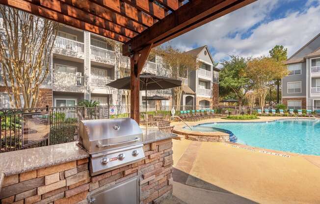 Lodge at Cypresswood Apartments - Poolside BBQ grills