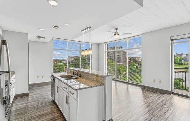 an open kitchen with a large window and a view of the city