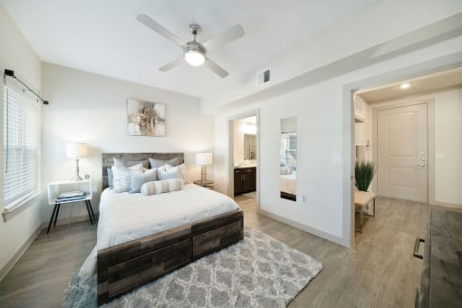 a bedroom with a large bed and a ceiling fan