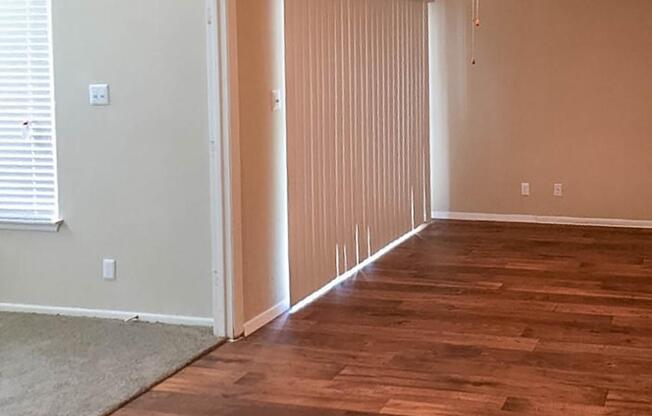 a large empty room with a wooden floor