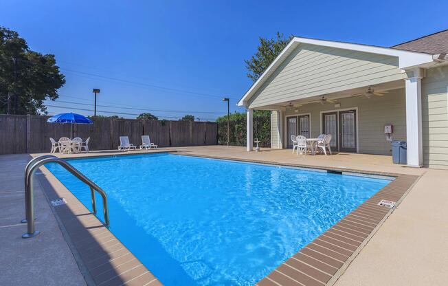 a house with a pool in front of a building