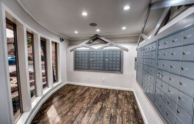 a wine cellar with a wooden floor and glass doors