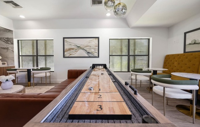 a room with a shuffleboard table in the center of it