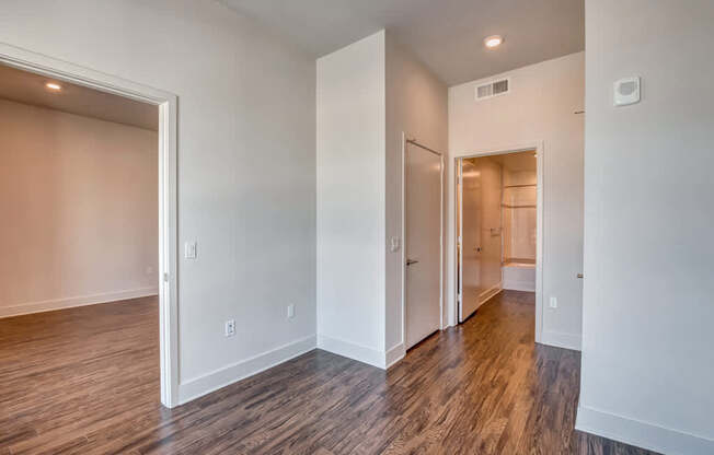 A room with wood flooring and white walls.