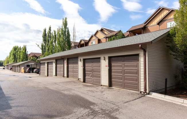 a row of garages in front of a house at Mullan Reserve Apartments, Montana, 59808