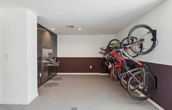 a group of bikes hanging on the wall in a room at Link Apartments® Broad Ave, Memphis, 38112