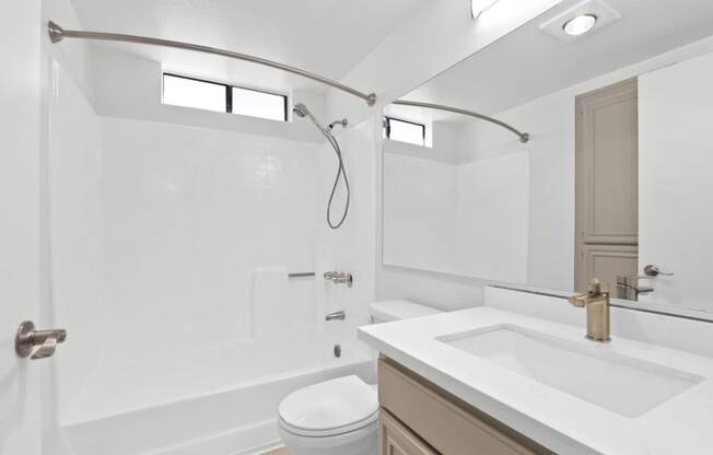 a bathroom with a sink toilet and a shower