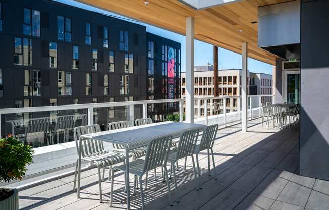 a patio with a table and chairs on a balcony at Slabtown Square Apartments, Portland , OR 97209