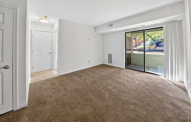 A room with brown carpet and white walls.