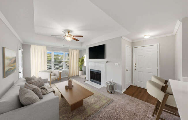 Spacious living area with fireplace and large windows.
