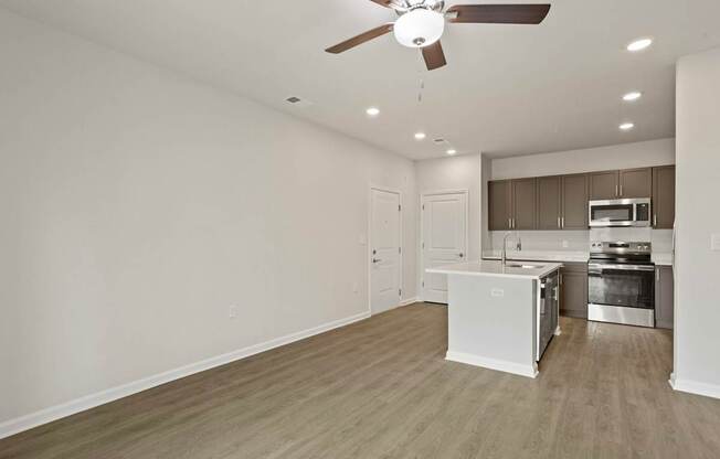 Grande at Geyser Falls Luxury Apartments Living Room and Kitchen with LVT Flooring
