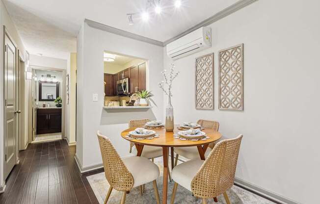 A dining room with a table set for four.