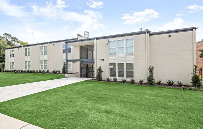 the front of an apartment building with a lawn and sidewalk at The Courts Midtown, Tennessee