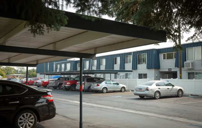 a parking lot with cars parked in front of a building