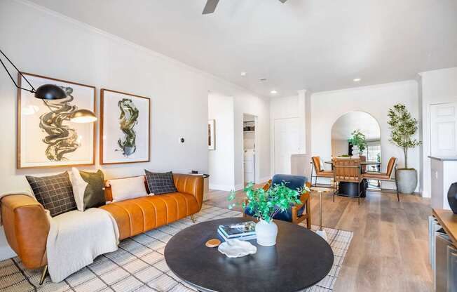 A living room with a brown couch and a black coffee table.