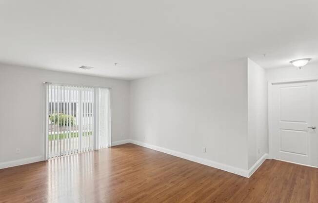 A room with wooden floors and white walls.