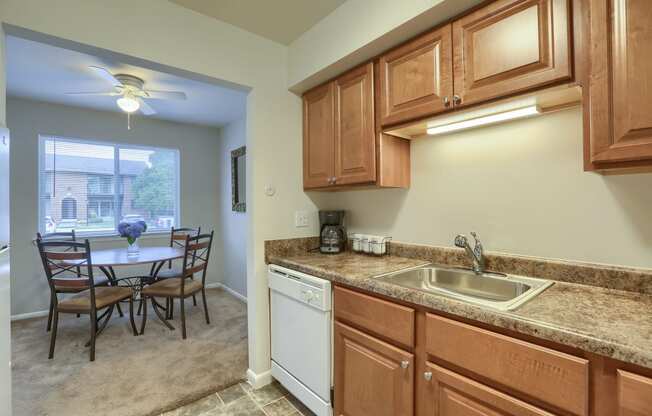 Mechanicsburg Apartments | Delbrook Manor Apartments | a kitchen with wooden cabinets and a white dishwasher