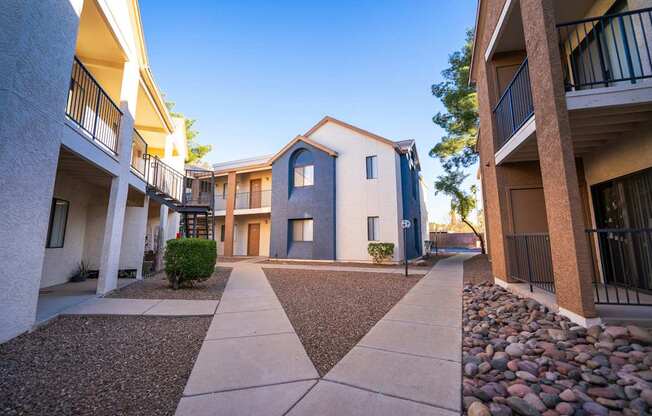 A sunny day at a residential complex with a clear blue sky.