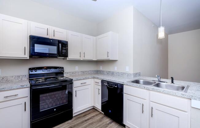 Apartments for Rent in Leander TX - Hills at Leander Spacious Kitchen with Plenty of Counterspace, Fully Equipped with Black Appliances, and Much More