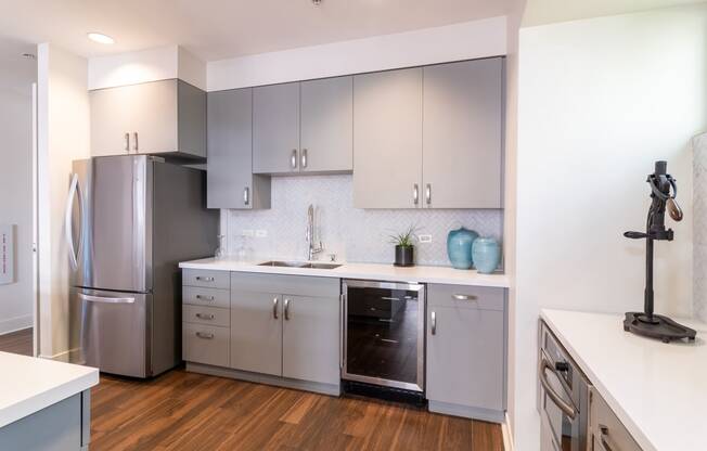 a renovated kitchen with stainless steel appliances and white cabinets