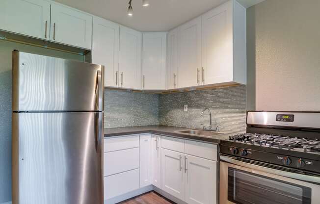 Apartments for Rent in Colton, CA - Las Brisas Kitchen with stainless steel appliances, and modern wood cabinets