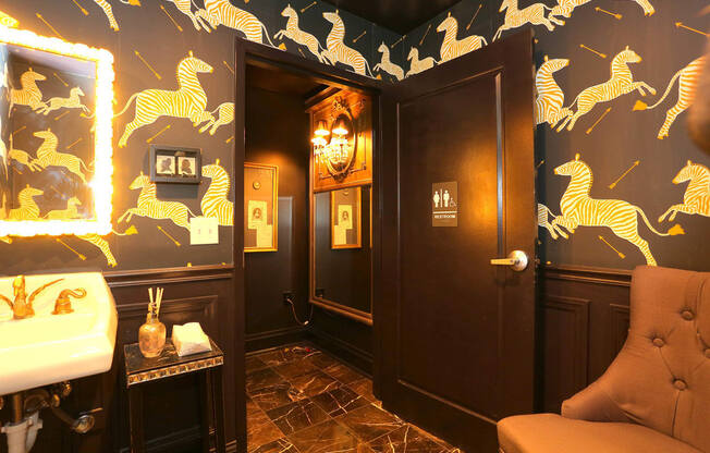 York House lobby restroom with zebra wallpaper and gold faucet at York House, Saint Louis, Missouri