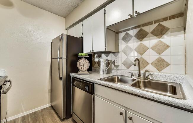 a kitchen with a sink and a mirror