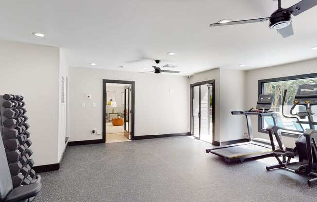 a workout room with treadmills and a treadmill