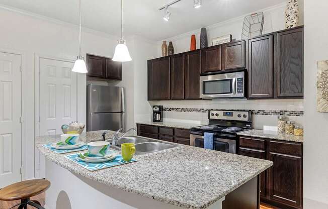Modern kitchen with stainless steel appliances and granite counter tops at Mansfield on the Green, Milwaukie, 76063