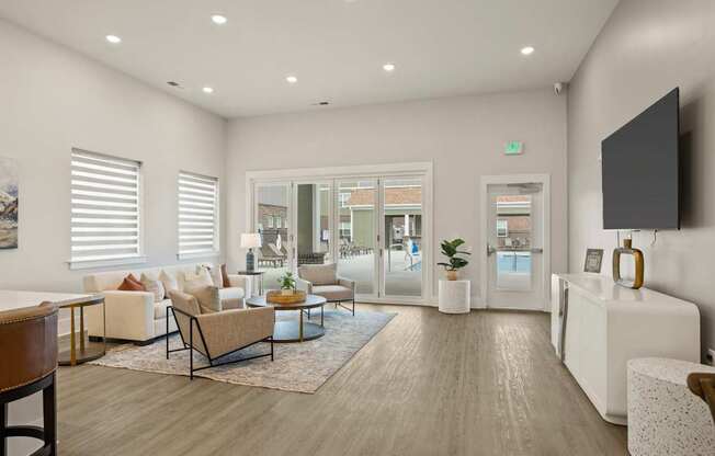 A modern living room with a wooden floor and white walls.