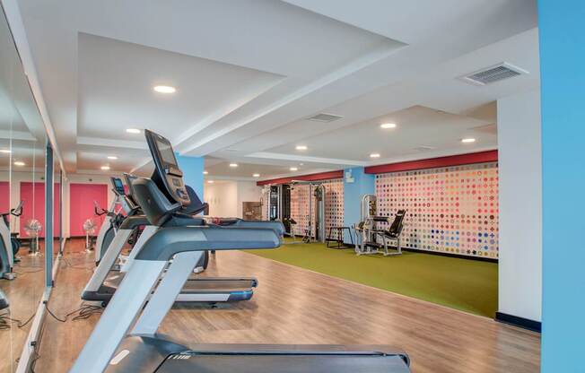 A gym with treadmills and exercise equipment.