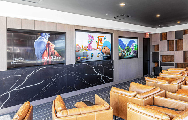 3thirty3 new rochelle ny apartment high rise photo of media room with leather club chairs and multiple televisions TVs and modern accents