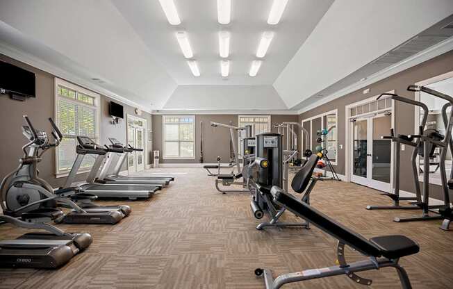 A gym with treadmills, elliptical machines, and weight machines.