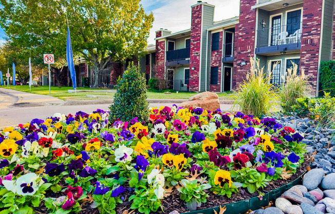 Flowers in the front of Townhouse apartments in ennis tx