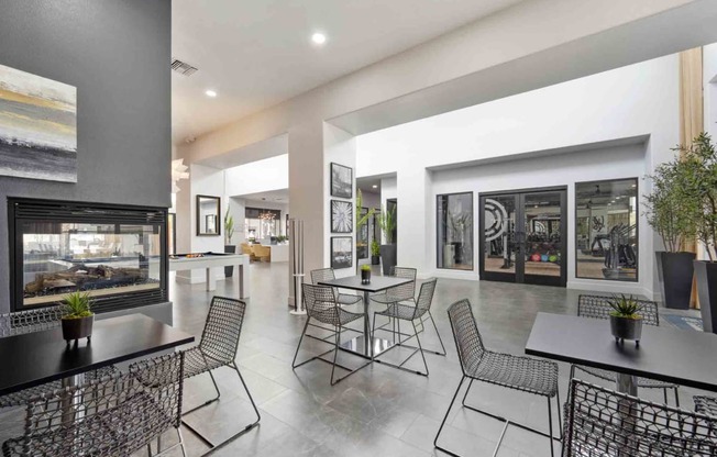 a room with tables and chairs and a fireplace