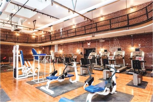 a gym with a bunch of exercise equipment in it