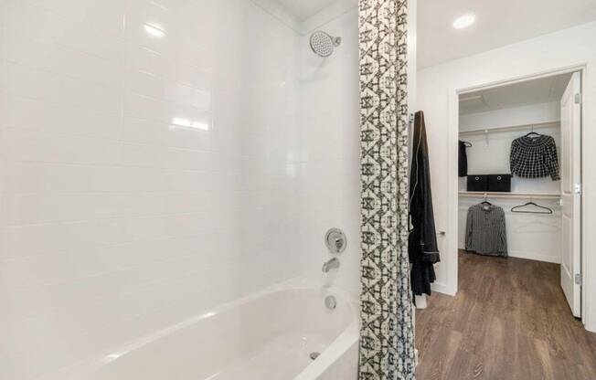 Model bathroom and walk-in closet at Glen 91 Apartments in Glendale, AZ