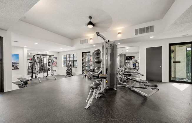 A spacious gym with a variety of equipment.