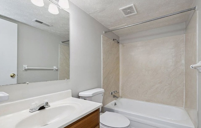 a bathroom with a sink toilet and a tub