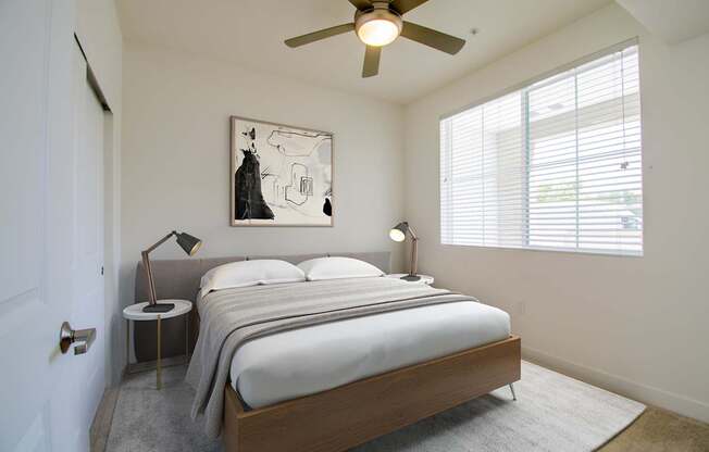 a bedroom with a bed and a ceiling fan