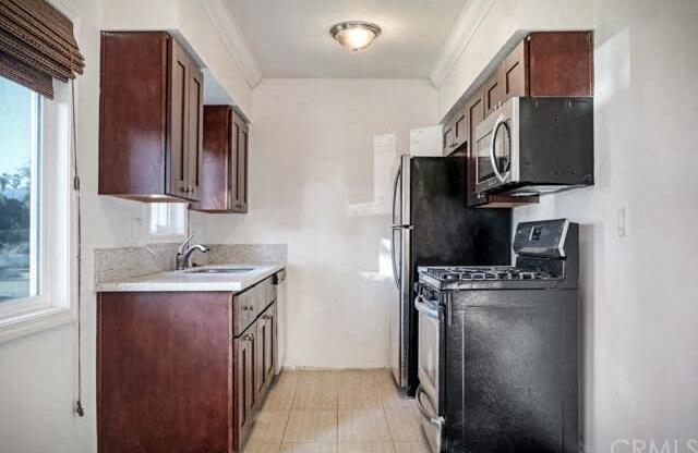 296 N. Oakland Apartments kitchen area with appliances, cabinets, and counters