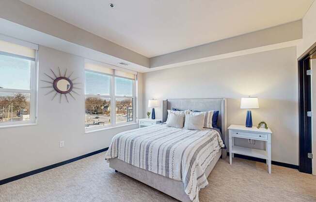 A bedroom with a large bed and a window overlooking a snowy landscape.